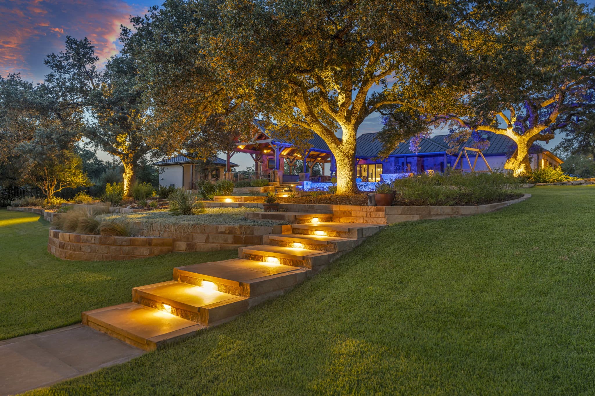 Image of a yard that is well lit from lawn light fixtures