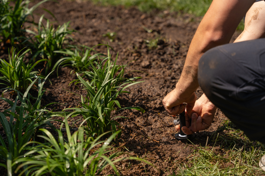 image of a tech preforming maintenance on a sprinkler